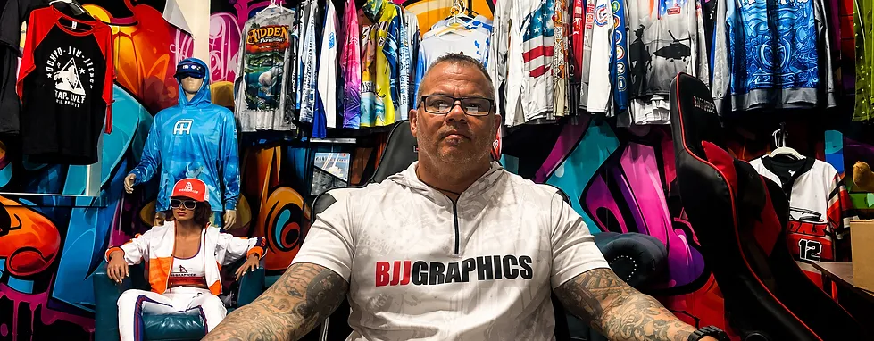 BJJ Graphics founder surrounded by custom apparel