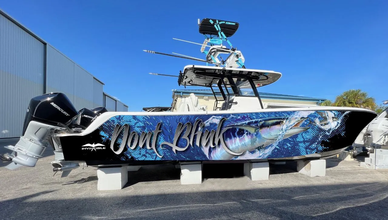 Invincible center console boat with a blue aquatic Dont Blink wrap