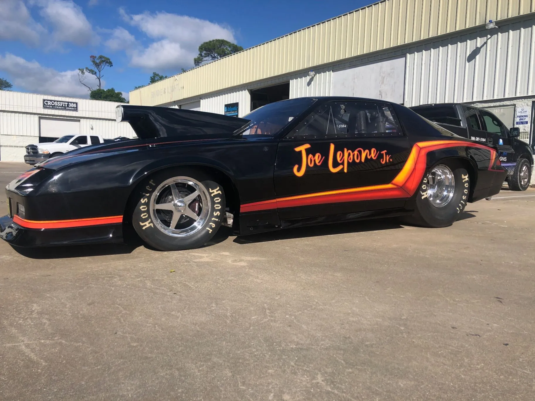 Black Joe Lepone Jr. drag car with red and orange custom graphics